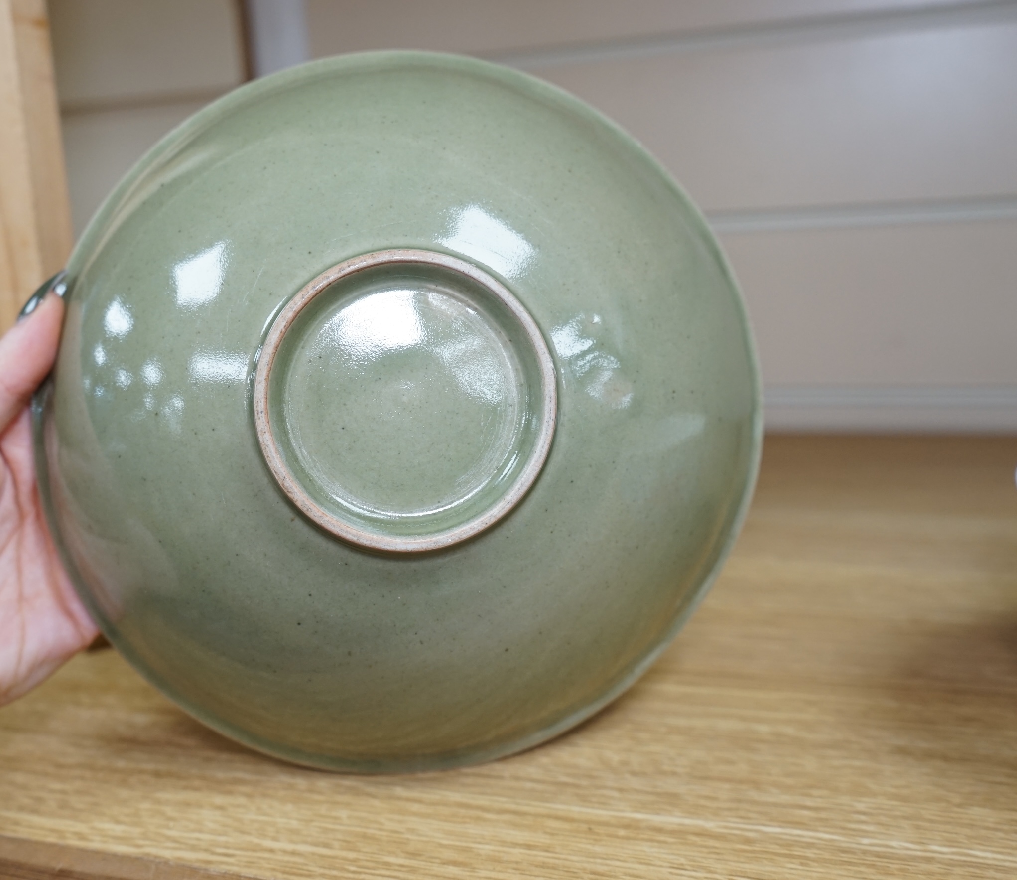 A Chinese Celadon glazed bowl and another, largest 19.5cm diameter. Condition - some wear